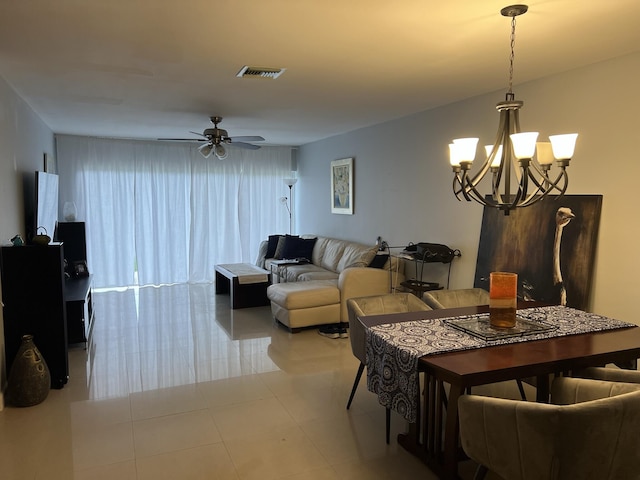 tiled dining room featuring ceiling fan with notable chandelier