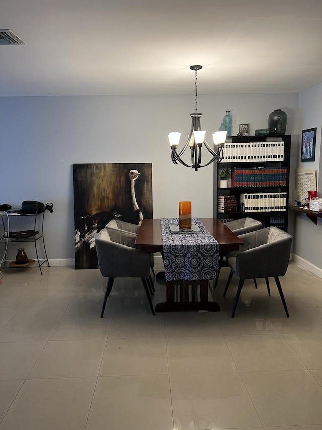 tiled dining area with a notable chandelier