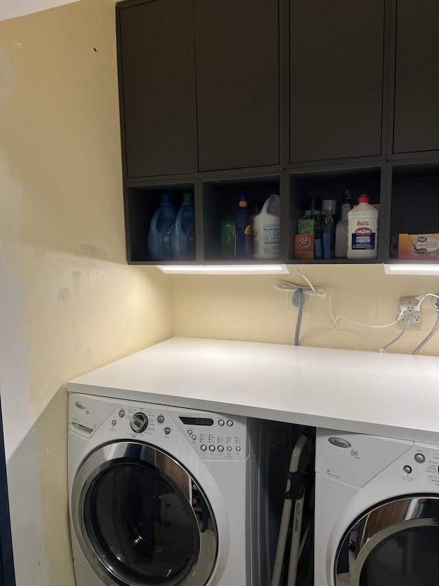 washroom featuring cabinets and independent washer and dryer