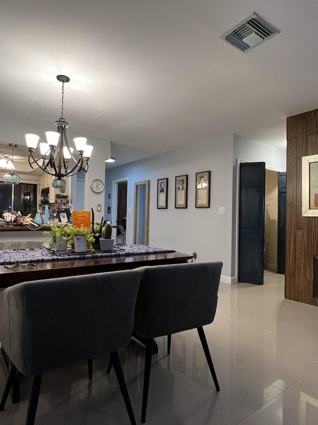 tiled dining room featuring a notable chandelier