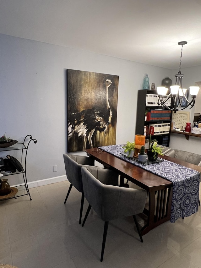 dining area featuring tile patterned flooring and a chandelier