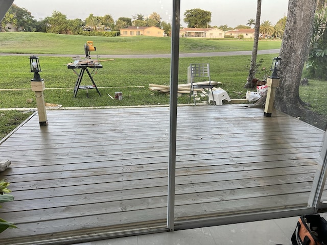 wooden terrace featuring a yard