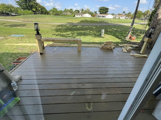 wooden deck featuring a yard