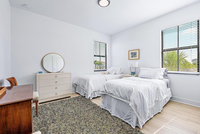 bedroom featuring light wood-type flooring and multiple windows