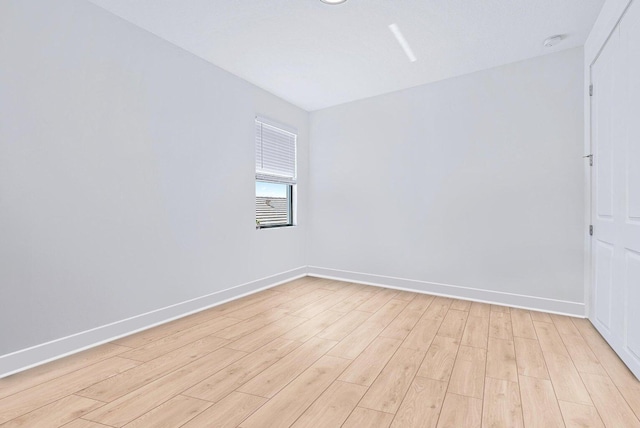 spare room with light hardwood / wood-style flooring