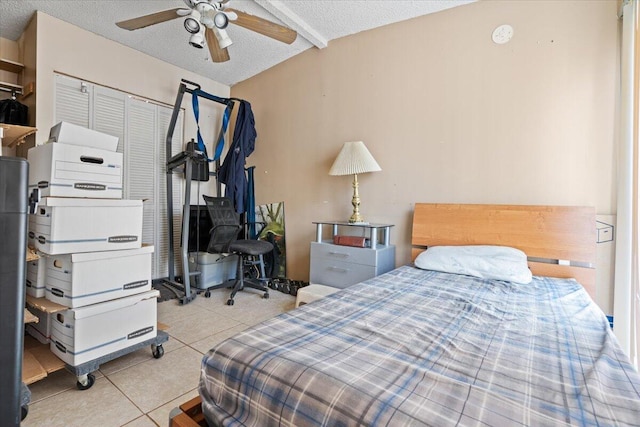 bedroom with light tile patterned floors, a textured ceiling, ceiling fan, and beam ceiling