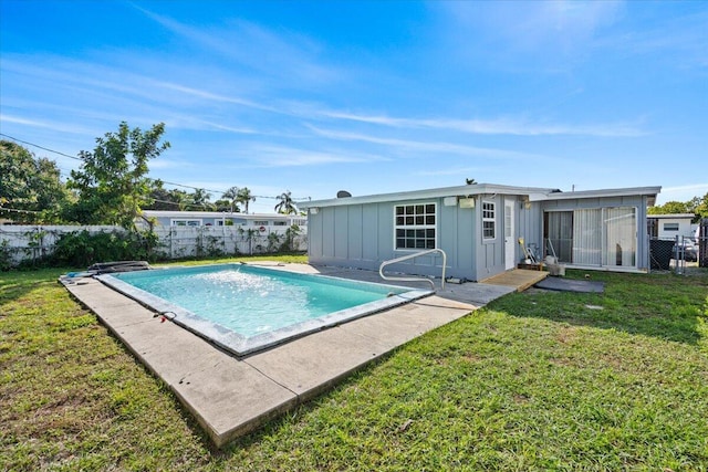 view of pool with a yard