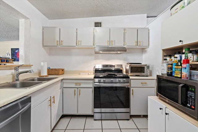 kitchen featuring white cabinetry, sink, stainless steel appliances, a textured ceiling, and light tile patterned flooring