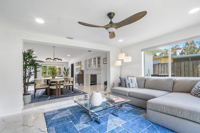 living room featuring ceiling fan and beverage cooler