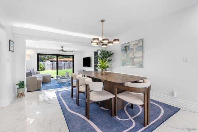 dining room with ceiling fan with notable chandelier