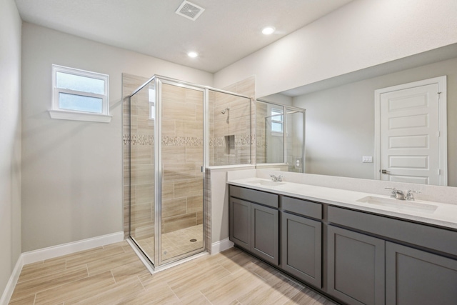 bathroom featuring vanity and a shower with shower door