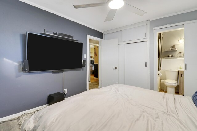 bedroom featuring ornamental molding, dark wood-type flooring, and ceiling fan