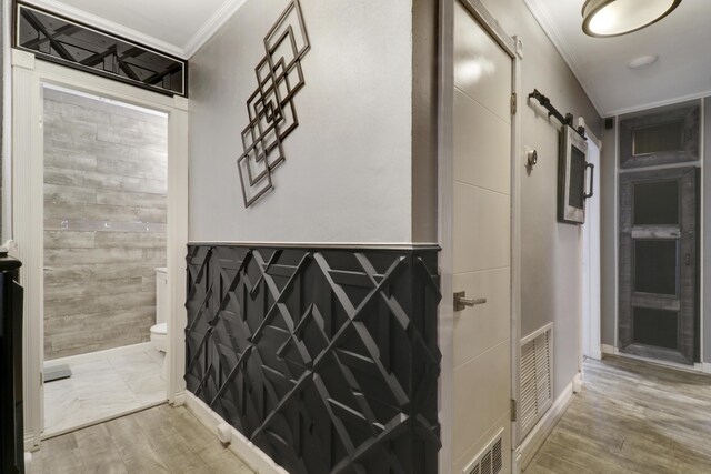 home office featuring crown molding and light hardwood / wood-style floors