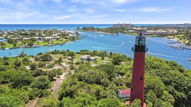 bird's eye view with a water view and a beach view