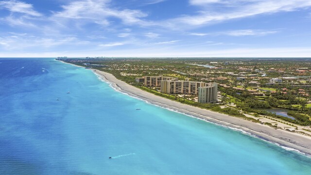 bird's eye view featuring a water view and a beach view