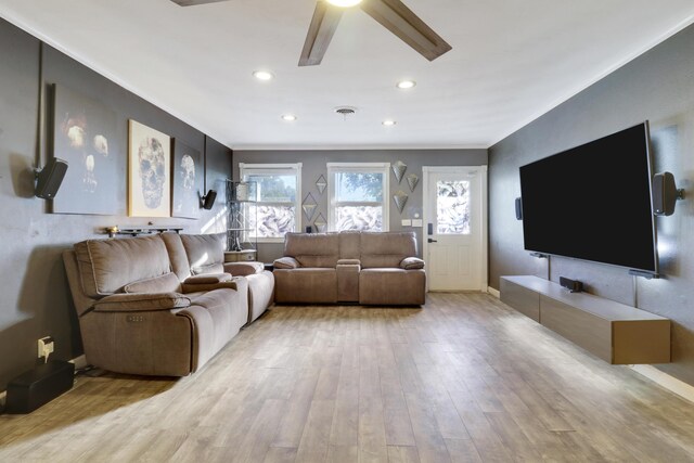 living room with crown molding and light wood-type flooring