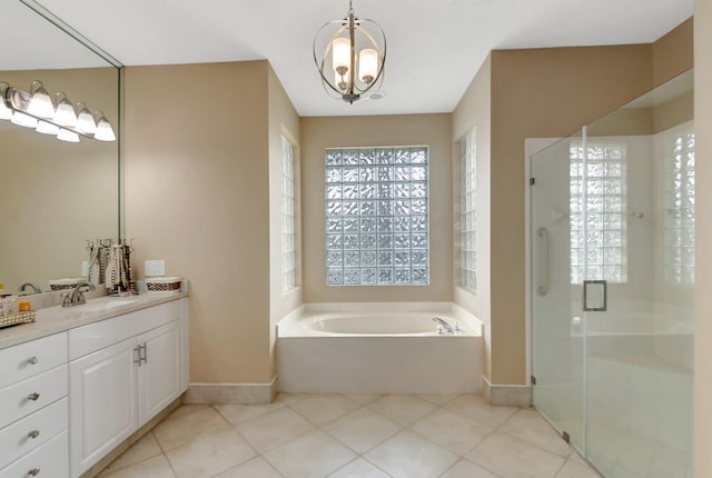 bathroom featuring tile patterned flooring, vanity, a notable chandelier, and plus walk in shower