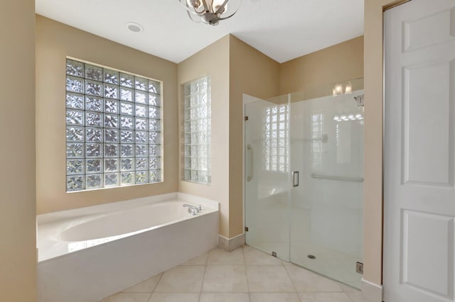 bathroom with tile patterned floors and plus walk in shower