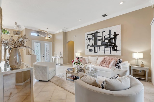 living room featuring light tile patterned flooring, crown molding, french doors, and a notable chandelier