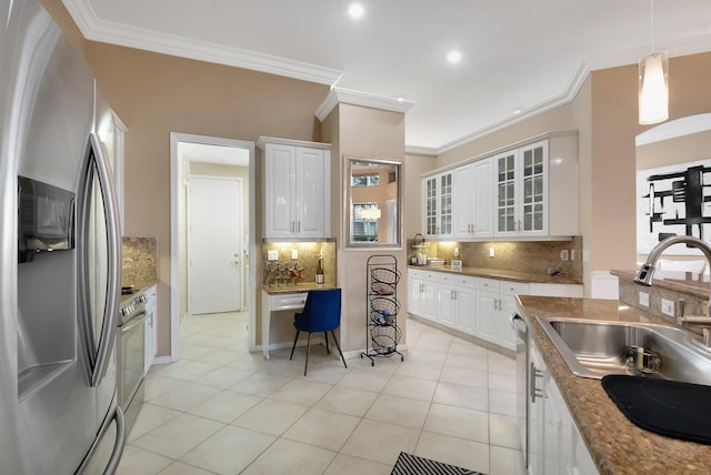 kitchen featuring white cabinets, appliances with stainless steel finishes, sink, and tasteful backsplash