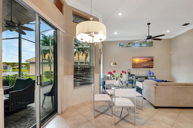 dining space featuring ceiling fan with notable chandelier, crown molding, and light tile patterned flooring