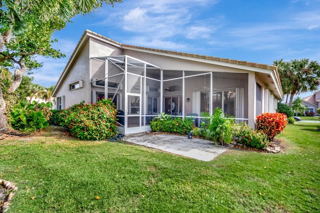 back of property featuring a yard and a patio