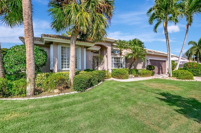 view of front facade featuring a front yard and a garage