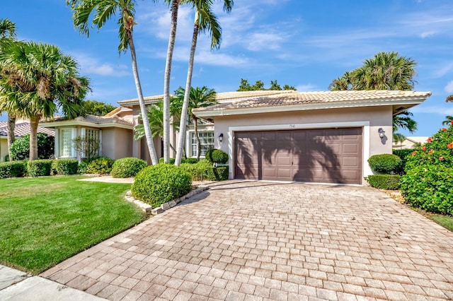 view of front facade with a front yard and a garage