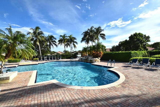 view of pool featuring pool water feature and a patio area