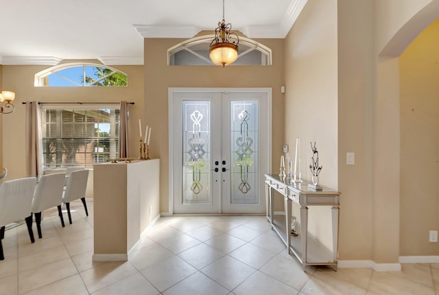 tiled foyer entrance featuring ornamental molding and french doors