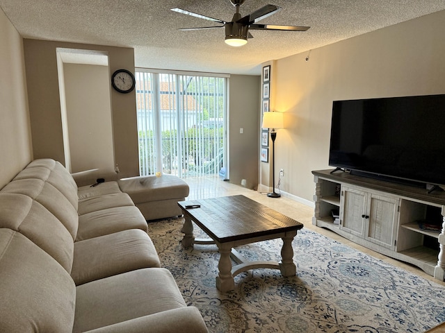 3113 Clint Moore Rd Unit 103, Boca Raton, FL 33496 - living room featuring a wall of windows, ceiling fan, a textured ceiling, and baseboards