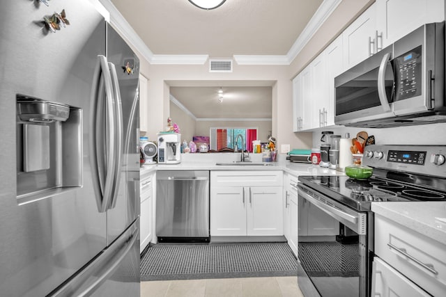 kitchen featuring white cabinets, ornamental molding, sink, and appliances with stainless steel finishes