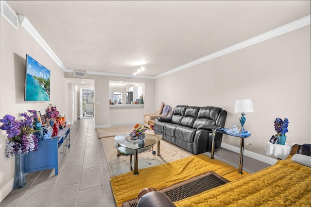 living room with tile patterned floors, a textured ceiling, and ornamental molding