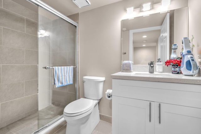 bathroom featuring walk in shower, tile patterned floors, vanity, and toilet