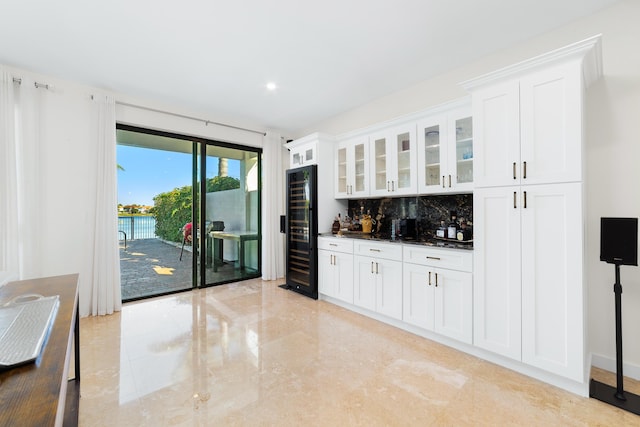 bar featuring white cabinets, decorative backsplash, and wine cooler