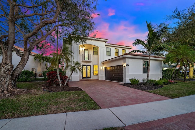 mediterranean / spanish-style home with a balcony and french doors