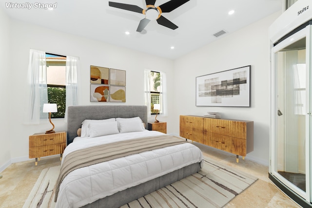 bedroom featuring ceiling fan and multiple windows