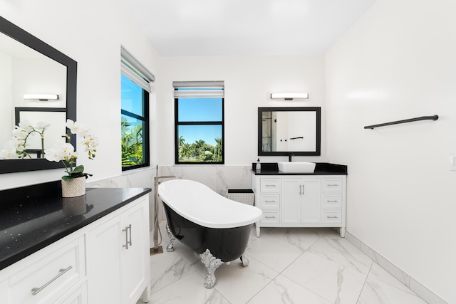 bathroom featuring vanity and a tub