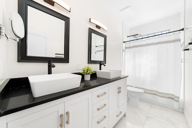 bathroom featuring vanity, toilet, and walk in shower