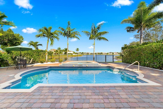 view of swimming pool with an in ground hot tub and a patio