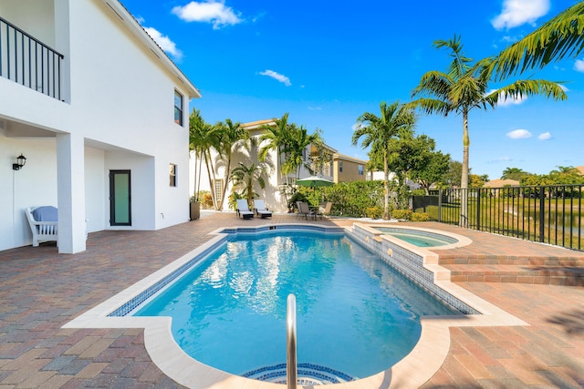 view of pool with an in ground hot tub and a patio