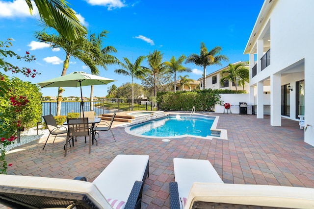 view of swimming pool featuring area for grilling, an in ground hot tub, and a patio