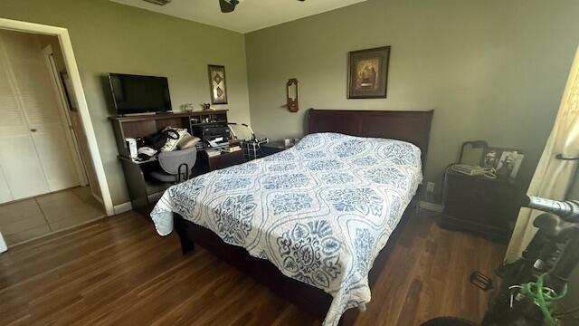 bedroom with dark wood-type flooring