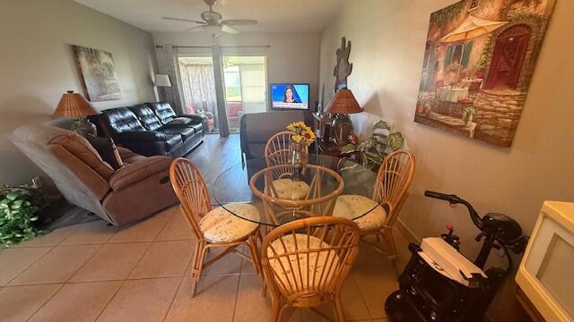 dining space featuring ceiling fan and light tile patterned floors