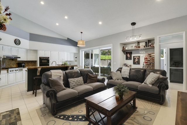 tiled living room featuring sink and high vaulted ceiling