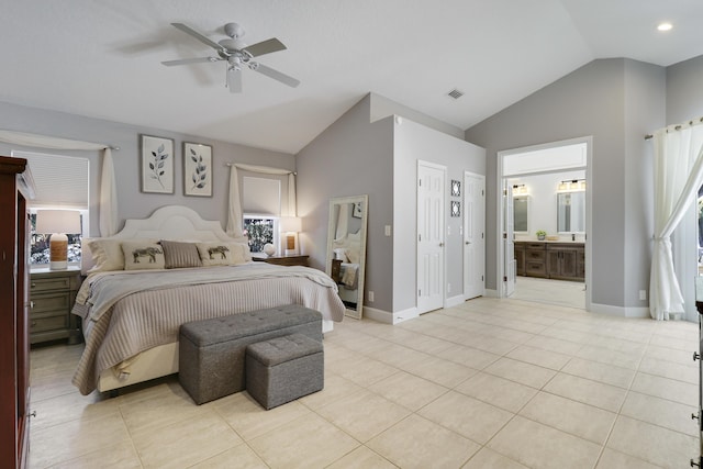 bedroom featuring connected bathroom, ceiling fan, light tile patterned floors, and vaulted ceiling