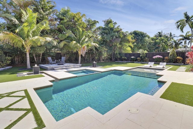 view of swimming pool featuring an in ground hot tub, a patio, and a lawn