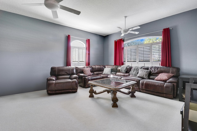 carpeted living room with ceiling fan