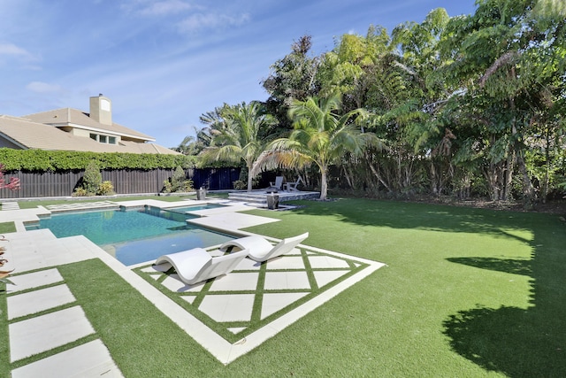 view of pool featuring a lawn and a patio