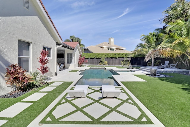 view of swimming pool with a lawn and a patio area